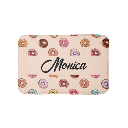 Niedliche dekorative Donuts auf rosa Badematte (Vorderseite)