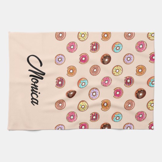 Niedliche dekorative Donuts auf rosa Geschirrtuch (Horizontal)