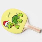 Niedliche glückliche Schildkröte mit Weihnachtsman Tischtennis Schläger (Seitenansicht)