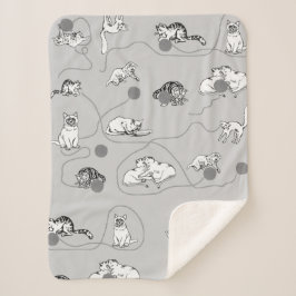 Niedliche Katzen spielen und ein schwaches Muster  Sherpadecke