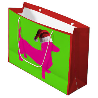 Niedliche rosa Dackel mit einem Weihnachtshut Große Geschenktüte