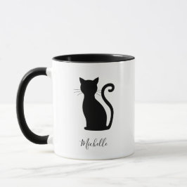 Niedliche schwarze Katze mit schwarzem und weißem  Tasse