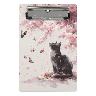 Niedliche schwarze Katze und Schmetterling unter r Mini Klemmbrett