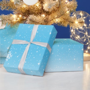 Niedliche und festliche Schneeflocke strahlend bla Geschenkpapier