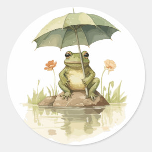 Niedlicher Frosch mit einem Regenschirm am See Runder Aufkleber