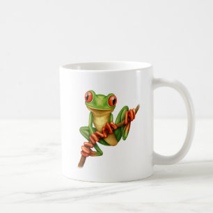 Niedlicher grüner Baum-Frosch auf einer Kaffeetasse