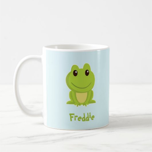 Niedlicher grüner Frosch auf blau Kaffeetasse (Links)