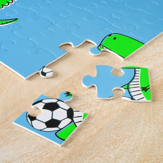 Niedlicher grüner Fußball-Dino T-Rex auf blau Puzzle (Seite)