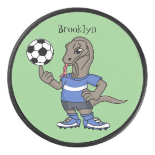 Niedlicher Komodo-Drache beim Fußballspielen Carto Eishockey Puck