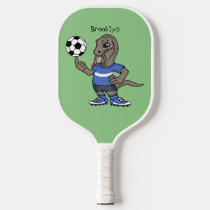 Niedlicher Komodo-Drache beim Fußballspielen Carto Pickleball Schläger