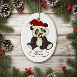 Niedlicher Panda-Bär Personalisiert Weihnachten Keramikornament<br><div class="desc">Hier ist ein bezaubernder personalisierter Weihnachtsschmuck für ein kleines Kind. Die Vorderseite zeigt ein niedliches Baby Panda Bären Cartoon Bild. Der Bär trägt eine rot-weiße Weihnachtsmannmütze und nibbelt auf einem gestreiften Bonbons. Unter dem Bild befindet sich ein weißes, rot gesäumtes Scrollbanner, das mit dem eigenen Text in schwarz gesäumt ist....</div>