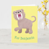 Niedlicher Säbeltoothy Tiger Smilodon Cartoon Karte (Gelbe Blume)