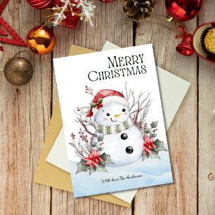 Niedlicher Schneemann mit Weihnachtsmannmütze und Feiertagskarte
