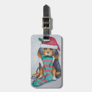 niedlicher, schwarz-brauner Welpe, zu Weihnachten  Gepäckanhänger