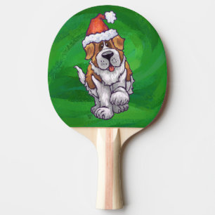Niedlicher St. Bernard in Weihnachtsmannmütze auf  Tischtennis Schläger