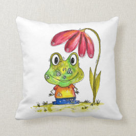Niedlicher Whimsical Green Frosch unter einer rote Kissen