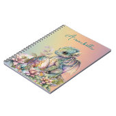 Niedliches Baby Dragon Ei auf Regenbogen Notizblock (Linke Seite)