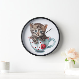 NIEDLICHES BROWBBY KITTEN IN EINER ROTEN WEISSEN K UHR