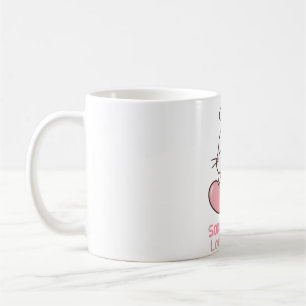 Niedliches Kaninchen, ein paar sonnige Lieben, die Kaffeetasse