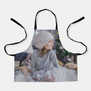 Niedliches kleines Kindermädchen und Weihnachtsbau Schürze