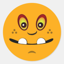 Niedliches Orangefarbenes Monstergesicht mit einem Runder Aufkleber