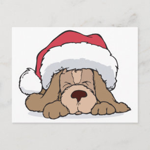 niedliches Welpe in Weihnachtsmannmütze Feiertagspostkarte