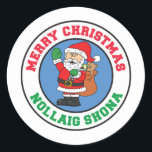 Nollaig Shona Irish Christmas Santa Runder Aufkleber<br><div class="desc">Nollaig Shona Irish Christmas Santa Round Aufkleber. Sagen Sie "Frohe Weihnachten" auf Irisch mit diesen niedlichen,  Cartoon Urlaub Weihnachtsaufklebern. Ideal für jedes irische Weihnachtsfest Party. Mit diesem niedlichen Design werden irische Kinder und Erwachsene in den Urlaubssgeist versetzt. Gut geeignet für Geschenk- oder Leckerei-Taschen.</div>