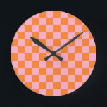 Orange und Rosa Runde Wanduhr<br><div class="desc">Abstrakte digitale Kunst von orangen und rosa Quadraten in einer karierten Formation.</div>