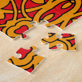 Orange- und rotes Handmuster Puzzle (Seite)