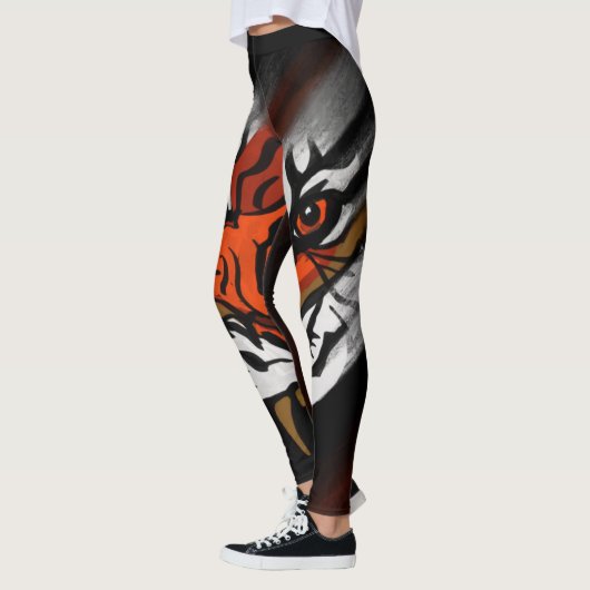 ORANGE- UND SCHWARZE STREIFEN LEGGINGS (Links)