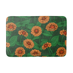 Orange Zinnia Blume, grüne Blätter auf dunkelgrün Badematte