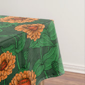Orange Zinnia Blume, grüne Blätter auf dunkelgrün Tischdecke (Beispiel)