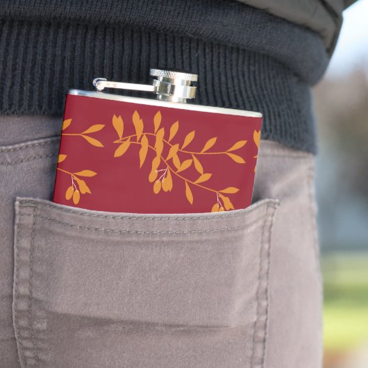 Orangefarbene Blätter der Silhouette auf rot Flachmann (Beispiel)