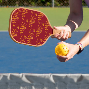 Orangefarbene Blätter der Silhouette auf rot Pickleball Schläger
