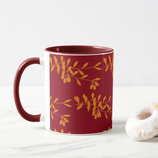 Orangefarbene Blätter der Silhouette auf rot Tasse (Mit Donut)