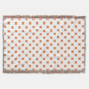 Orangefarbene Kreuzstiche auf weiß Decke