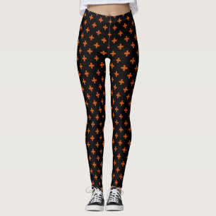 Orangefarbene Polka-Kreuze auf schwarz Leggings