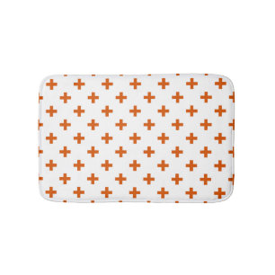 Orangefarbene Polka-Kreuze auf weiß Badematte