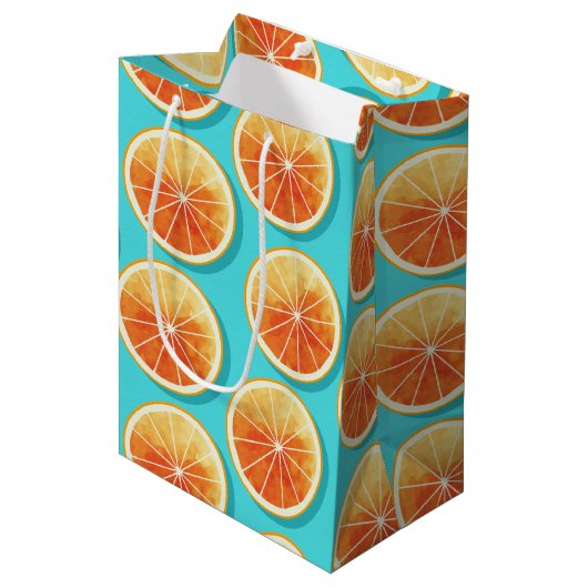 Orangefarbene Scheiben auf blau Mittlere Geschenktüte (Vorderseite Schrägansicht)