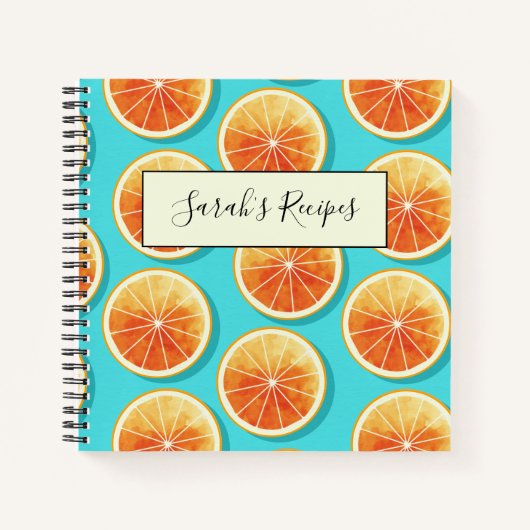 Orangefarbene Scheiben auf blau Notizblock (Vorderseite)