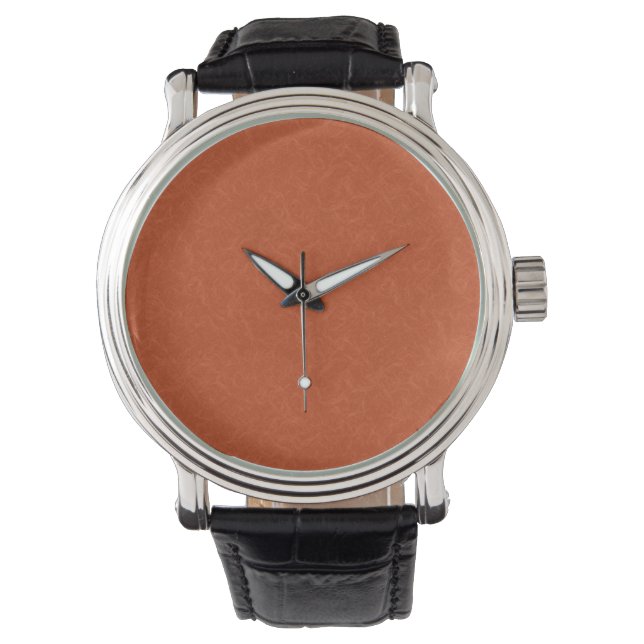 Orangefarbene texturierte Oberfläche mit wirbelnde Armbanduhr (Vorderseite)