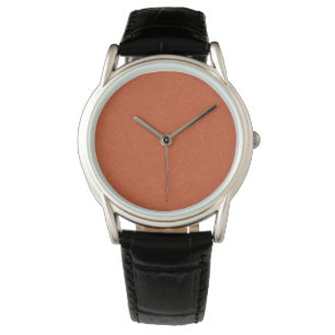 Orangefarbene texturierte Oberfläche mit wirbelnde Armbanduhr