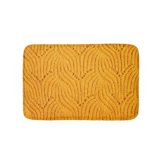 Orangefarbener Pullover, texturierter Hintergrund. Badematte (Vorderseite)