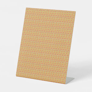 orangefarbener und gelber Hintergrund mit Muster Sockelschild