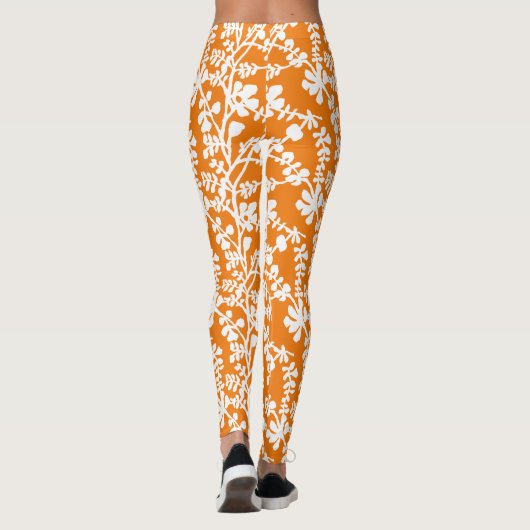 Orangefarbenes und weißes, florales Wiederholmuste Leggings (Rückseite)