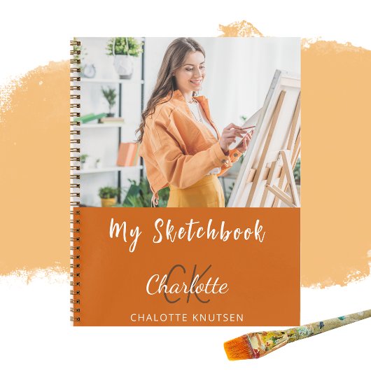 Orangenmonogramm des Sketchbook-Fotos Notizblock