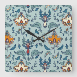 Ornate floral pattern on a pale blue background quadratische wanduhr