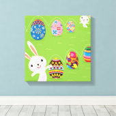 Osterhase spielerisch mit bemalten Eiern Leinwanddruck (Insitu (Holzboden))