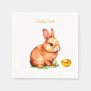 Osterhase und goldenes Ei auf weißen Servietten