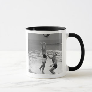 Paar spielt mit einem Strandball Tasse